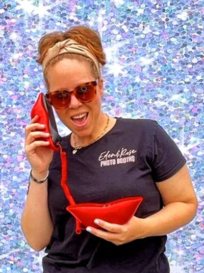 Eden & Rose photobooth attendant with props at an LA party