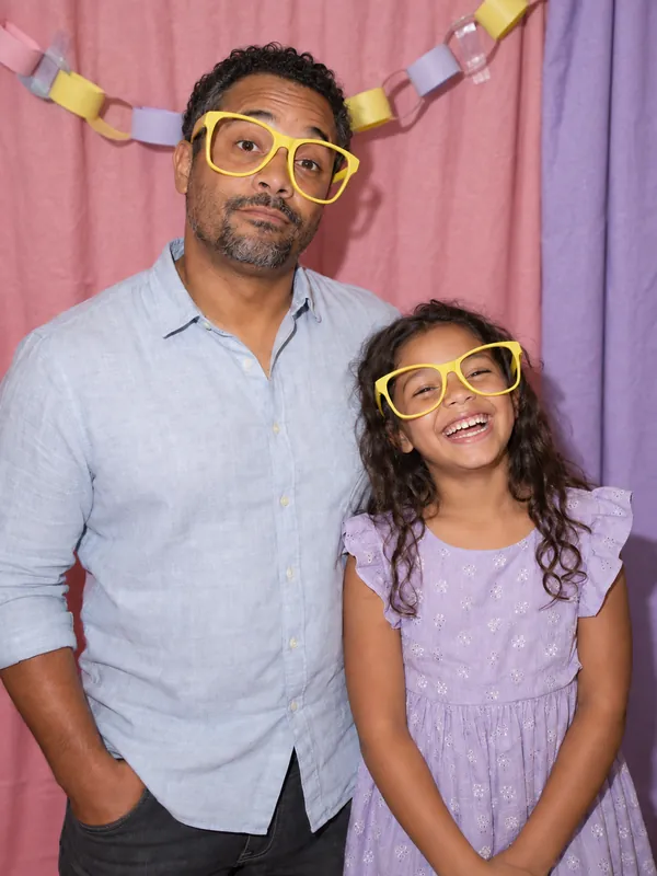 Dad and daughter in giant glasses at a Los Angeles photobooth